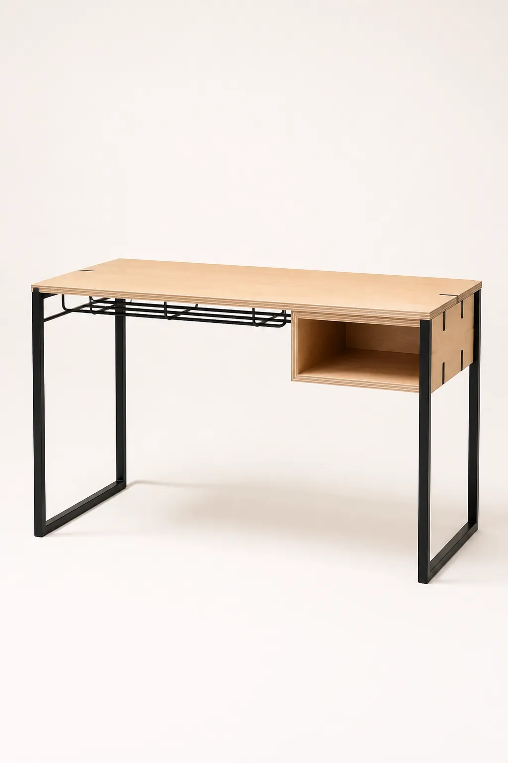 A writing desk with a wide birch plywood top, black steel legs and a cable rail beneath