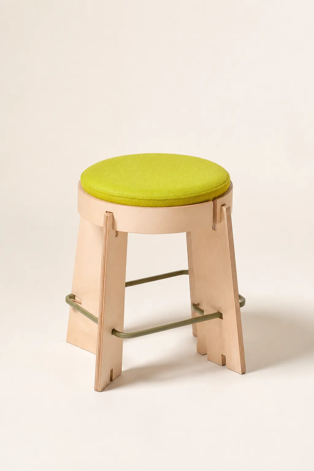 A compact stool with slotted birch plywood legs and a bright lime seat pad